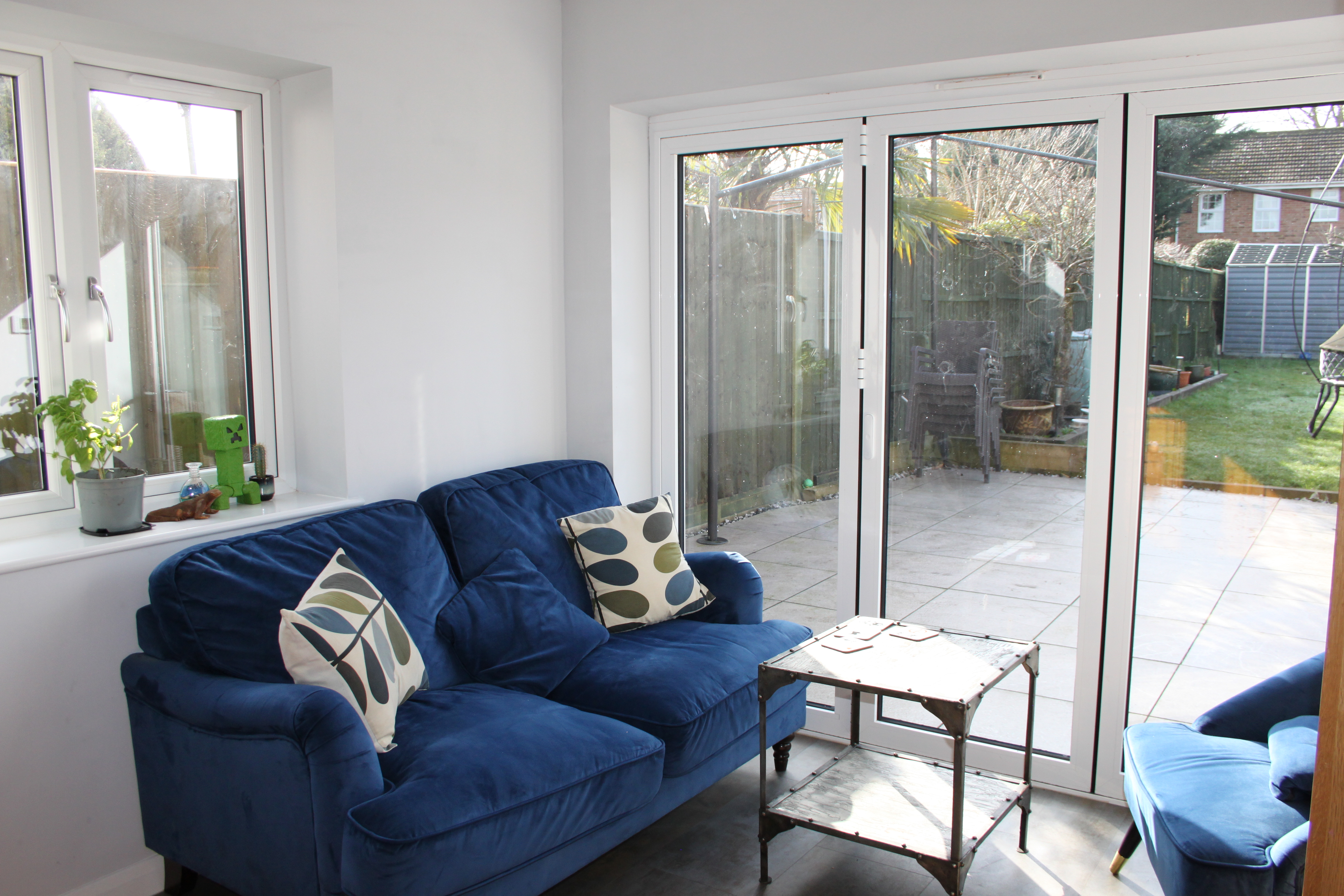Comfy modern sofas overlooking enclosed family garden