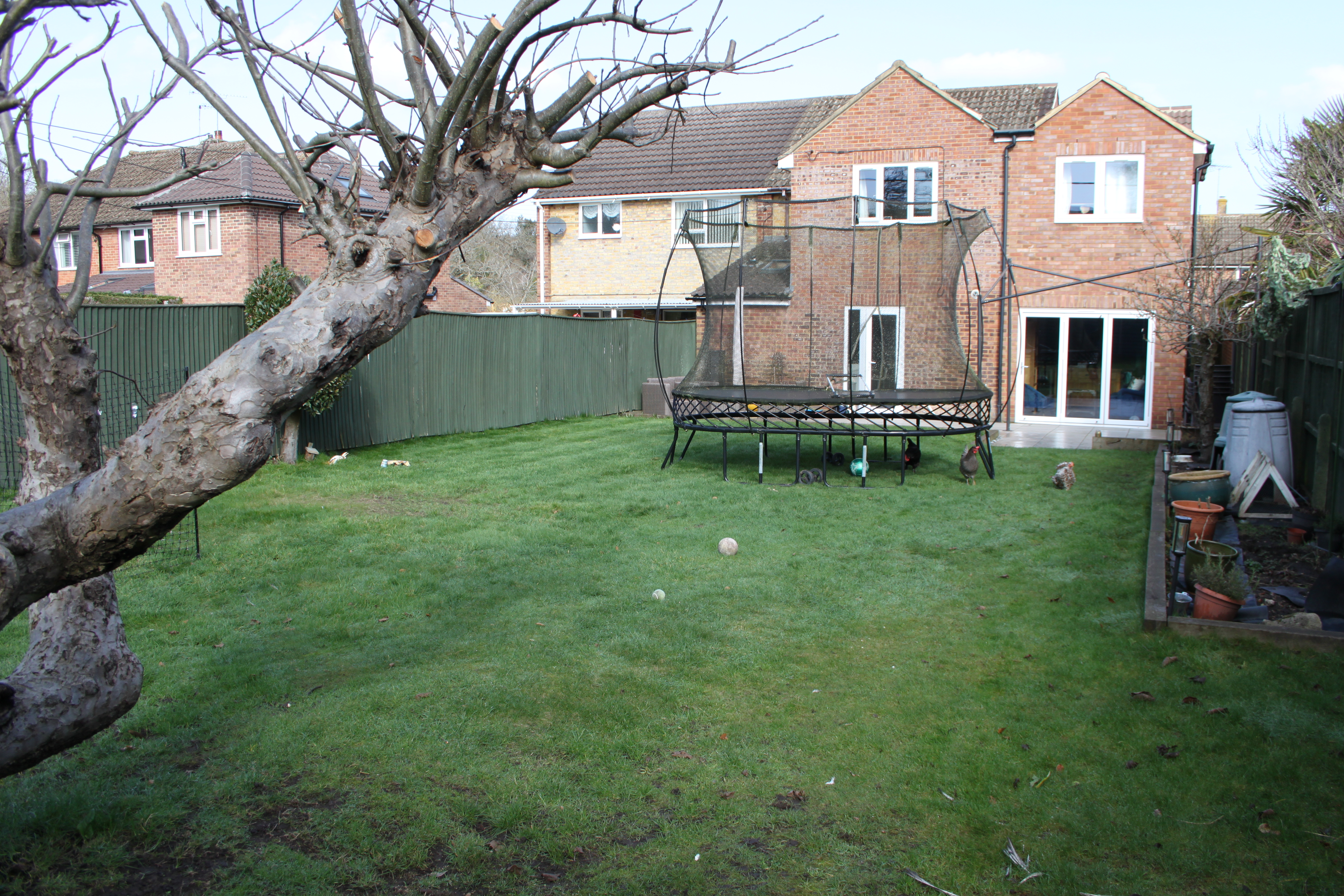 Sizeable family garden with grassy areas, tree, patio and patio seating. Trampoline can be moved. Pet chickens in garden available for shoot if needed!