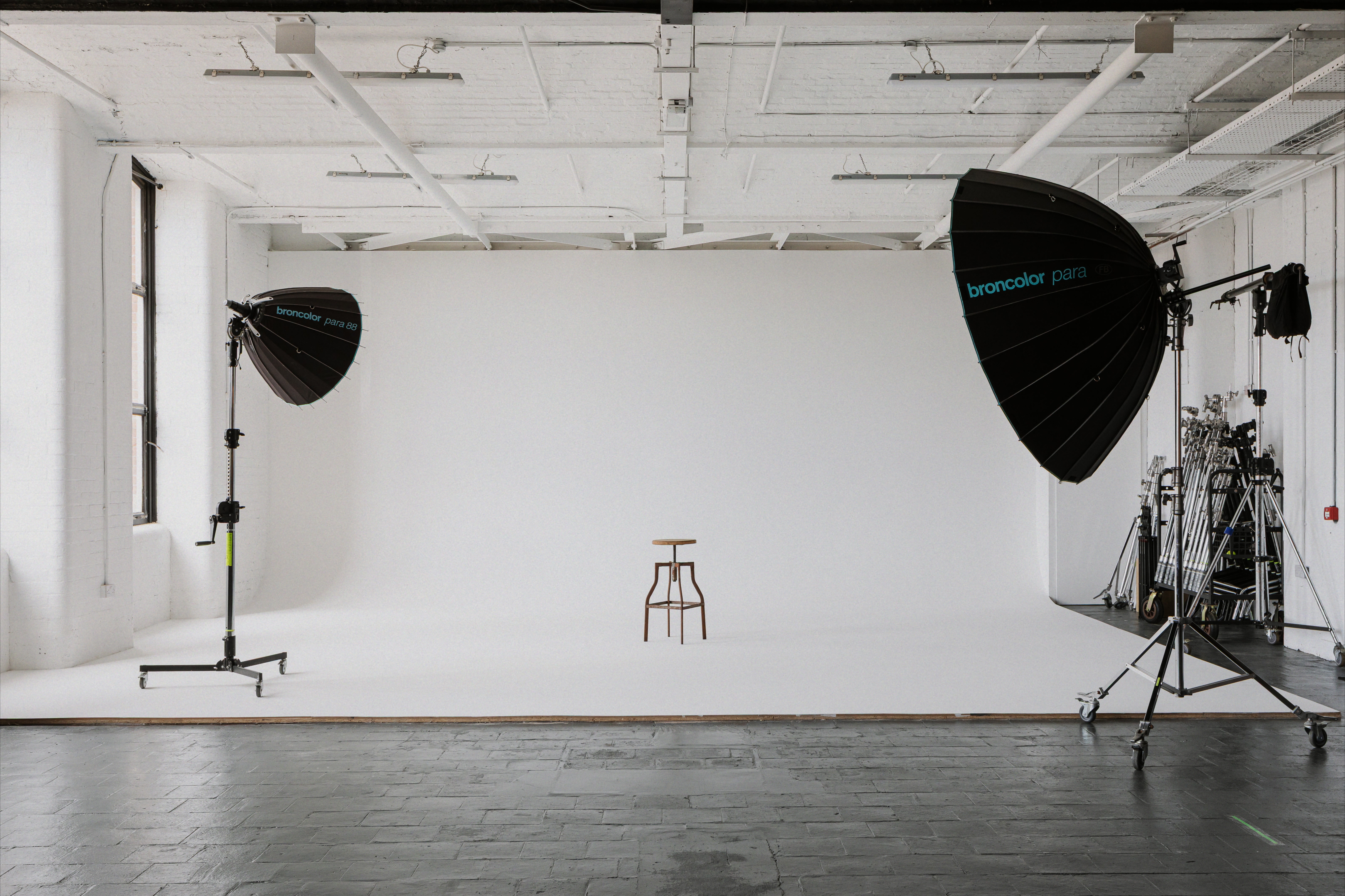 White cyclorama set up with Broncolor Para lighting and studio grip equipment.